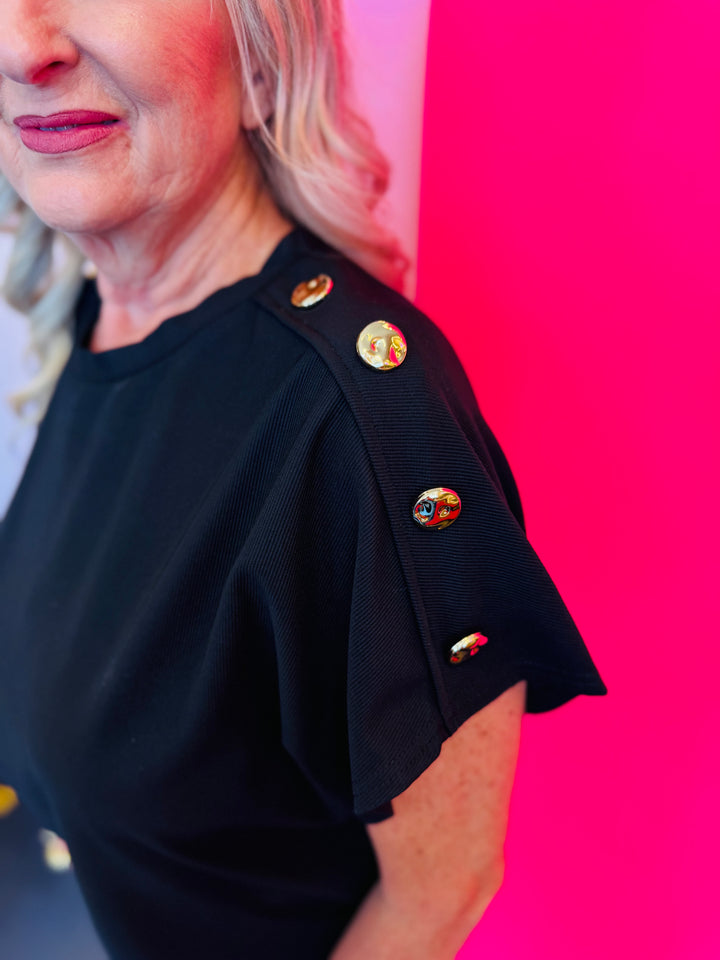 Close-up side view focusing on the row of gold buttons along the sleeve, adding a chic accent to the minimalist design.