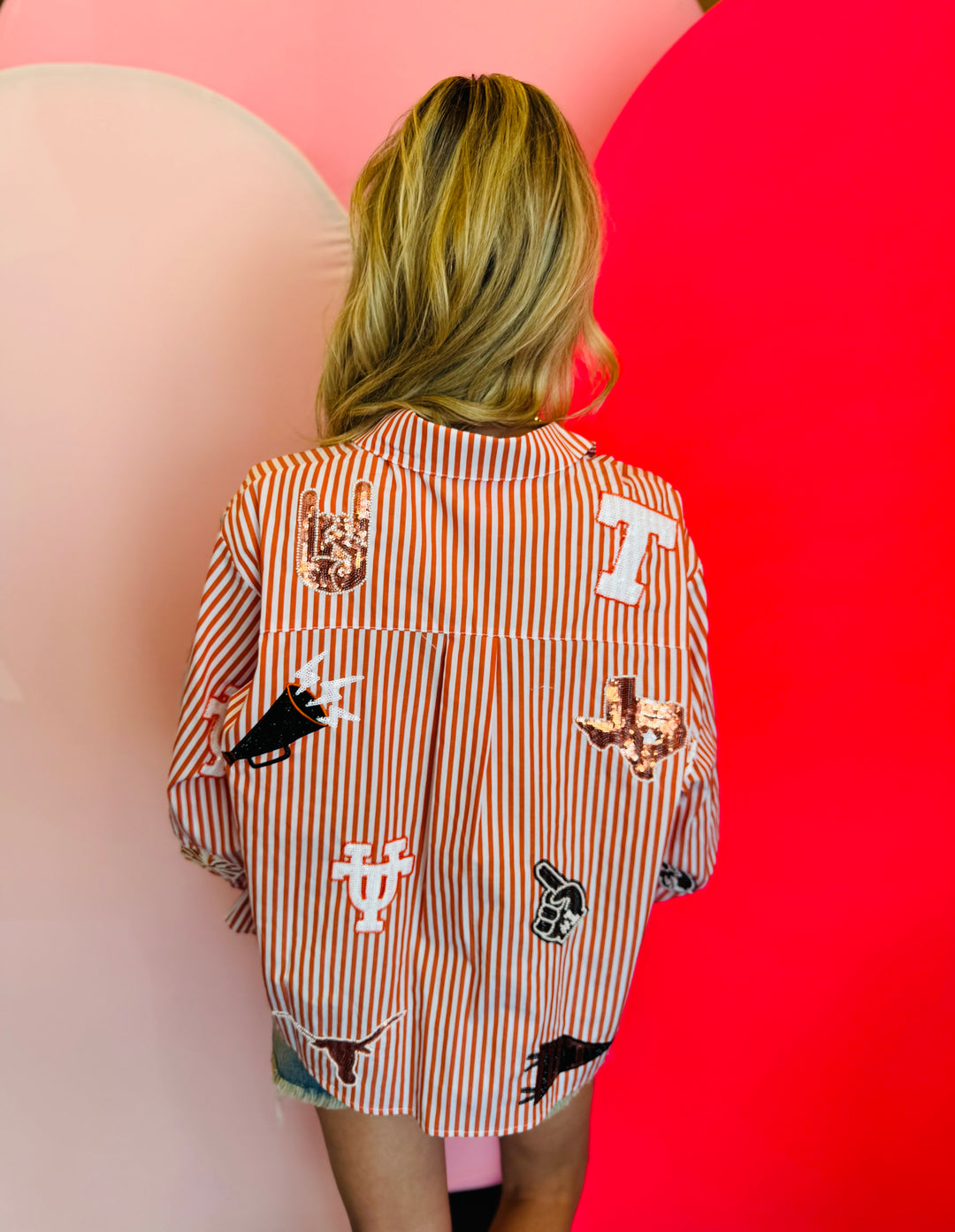 Back of Queen Of Sparkles orange and white striped icon University Of Texas game day blouse.