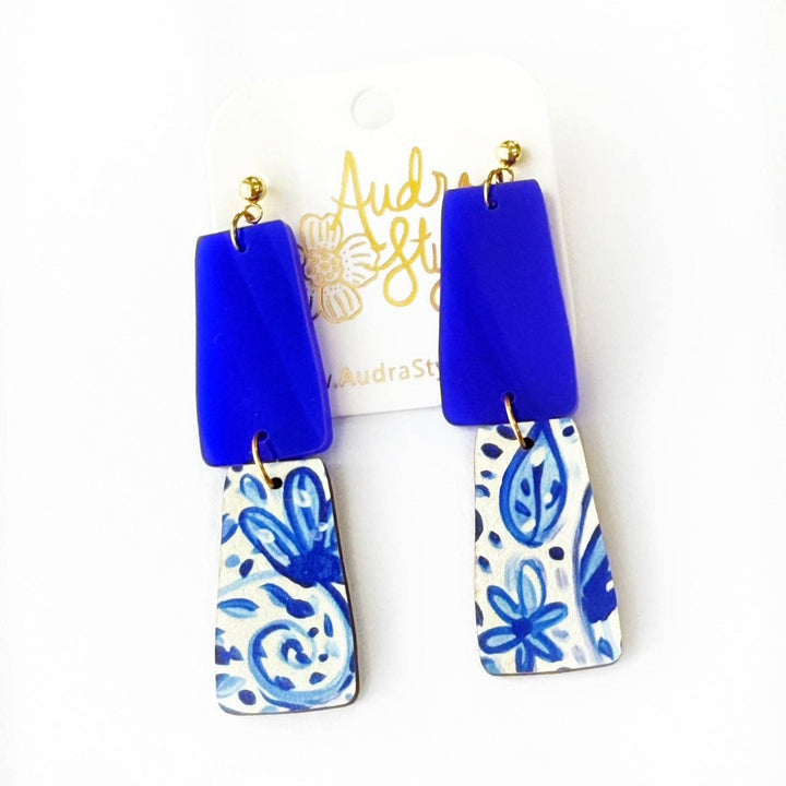 Blue and white patterned earrings on a from Audra Style branding.
