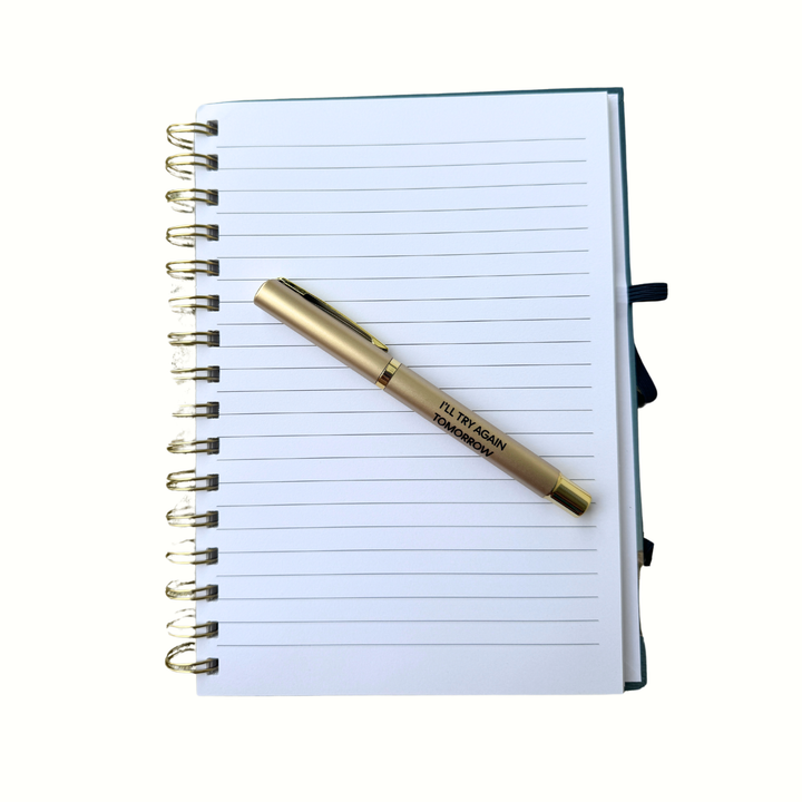Gold pen with black lettering reading “I’ll Try Again Tomorrow” 