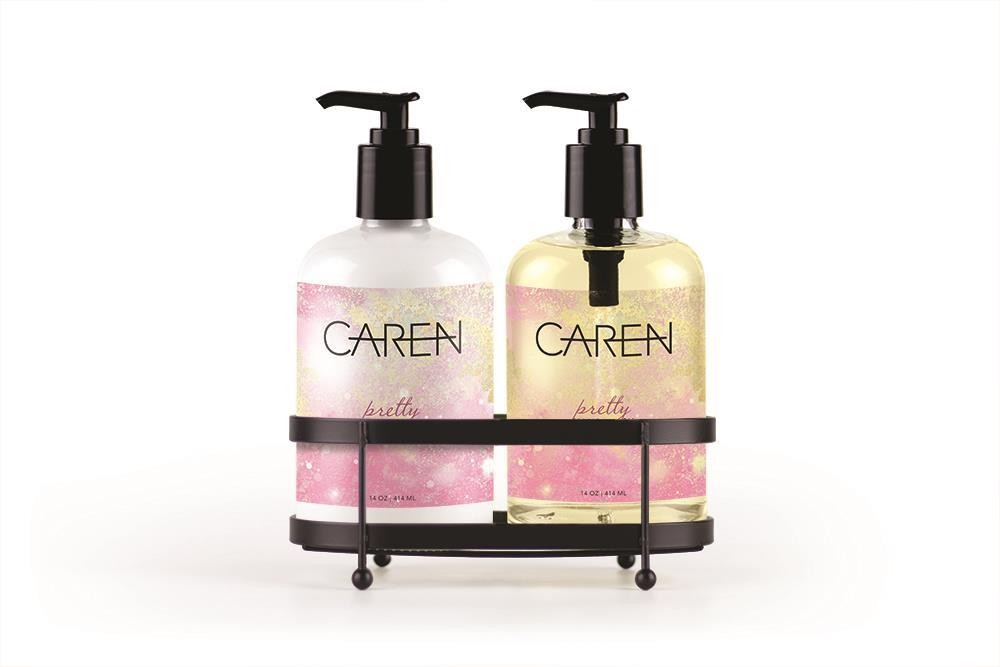 A 14 oz bottle of "Pretty" hand wash and a 14 oz bottle of hand treatment sitting in a black sink-side caddy.