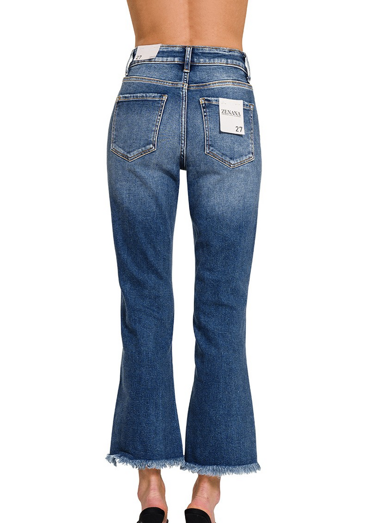 Mid-rise distressed denim pants with knee slits and raw hem; light wash with stretch fit shown on model.