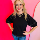 Black 3/4 balloon sleeve cotton top with crew neckline and white contrast stitching.