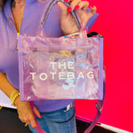 Transparent purple tote bag with 'THE TOTEBAG' text written on the bag.