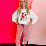 Cream long-sleeve sweater with a large red checkerboard lobster graphic and red striped trim.