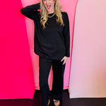 Black scuba lounge set with side slit top and wide-leg elastic waist pants.