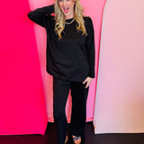 Black scuba lounge set with side slit top and wide-leg elastic waist pants.