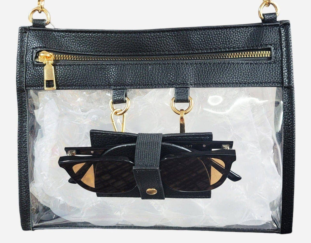 Clear crossbody bag with black trim and matching hardware, featuring a detachable sunglasses holder—elegant and event-ready.