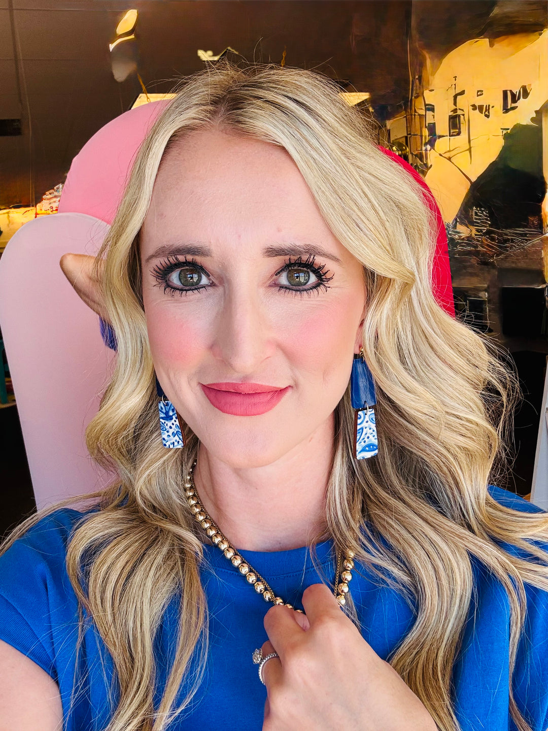 Model wearing the Blue White Floral Dangle Earrings, showcasing their playful link shape and crisp blue and white floral design against a casual outfit.