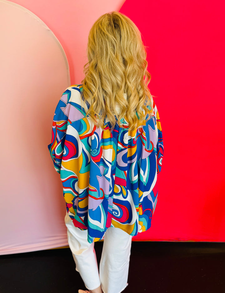 Back view of the blouse displaying the pinched detail at the upper back and the relaxed silhouette of the lightweight fabric.