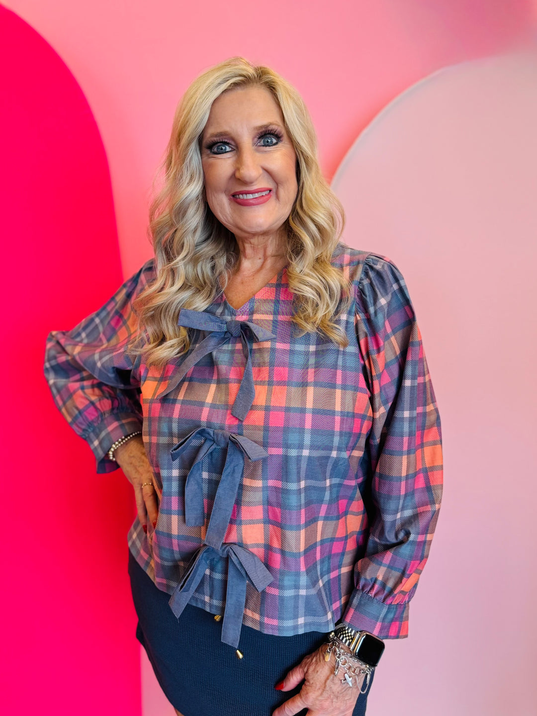 Plaid top in pink and blue with front bows, long sleeves.