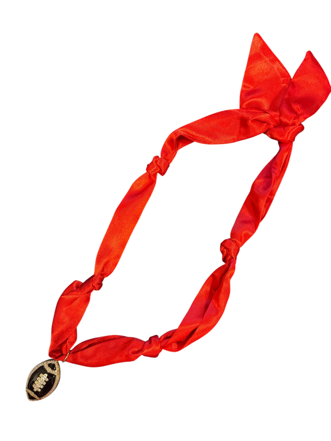 Red satin scarf necklace with a black rhinestone encrusted football charm.