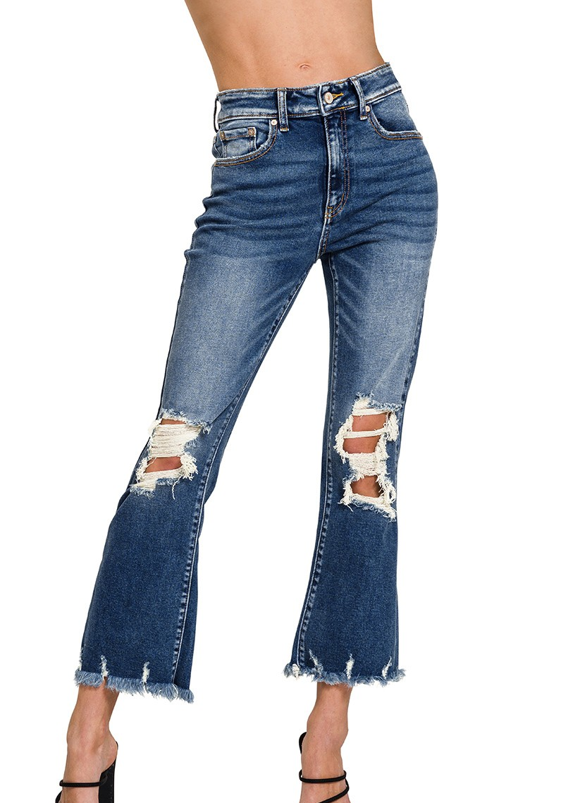 Mid-rise distressed denim pants with knee slits and raw hem; light wash with stretch fit shown on model.
