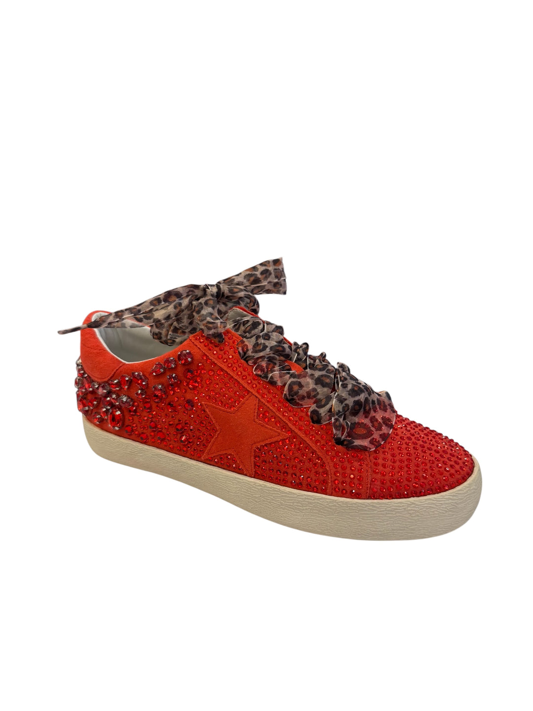 Side profile of red vegan leather sneaker featuring a bold rhinestone star embellishment and slight platform heel with leopard laces.