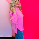 Side profile of the sweater highlighting the brushed texture, side slit detail, and hi-low silhouette for added movement and layering.