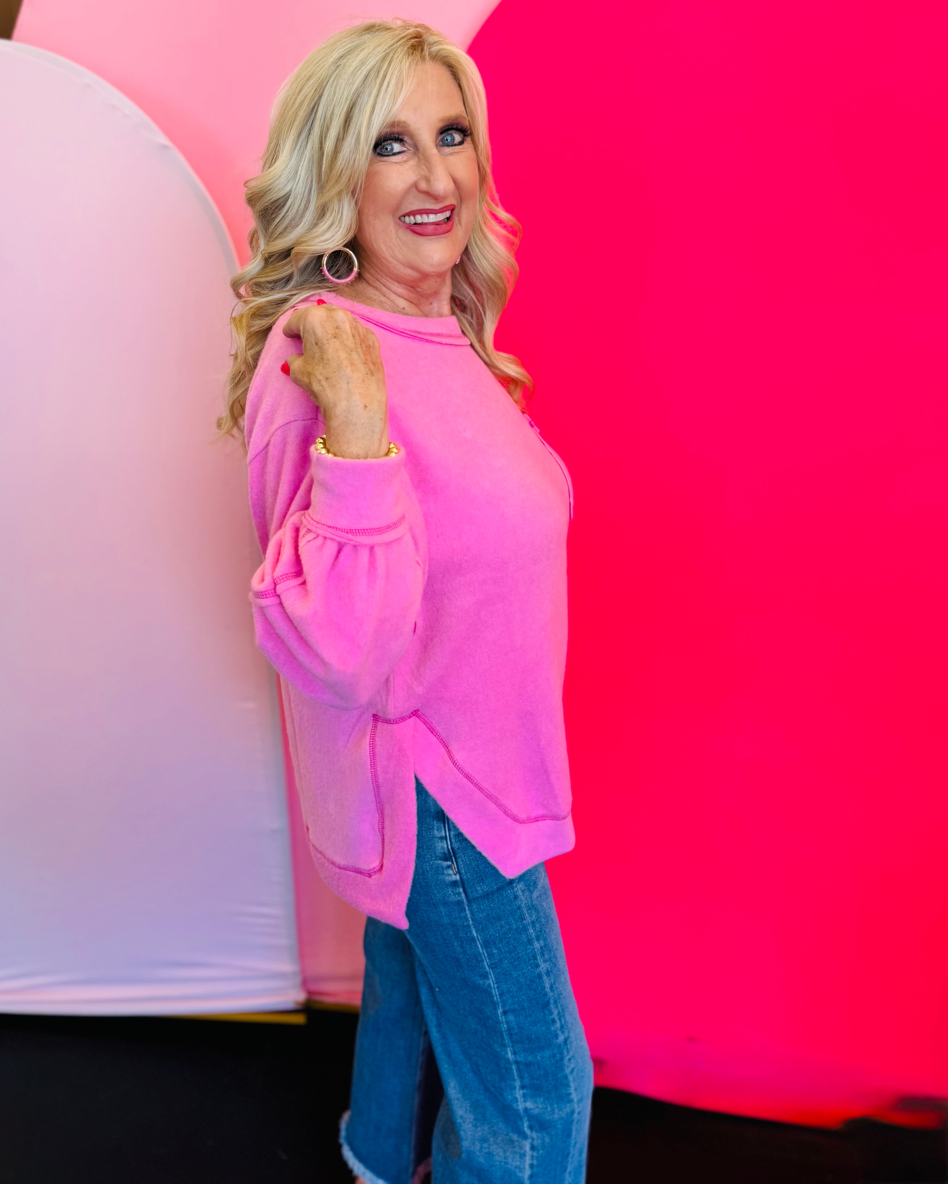 Side profile of the sweater highlighting the brushed texture, side slit detail, and hi-low silhouette for added movement and layering.