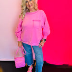 Full outfit shot featuring the Candy Pink Hi-Low Sweater paired with jeans and a coordinating pink purse for a cute and casual look.
