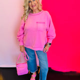 Full outfit shot featuring the Candy Pink Hi-Low Sweater paired with jeans and a coordinating pink purse for a cute and casual look.