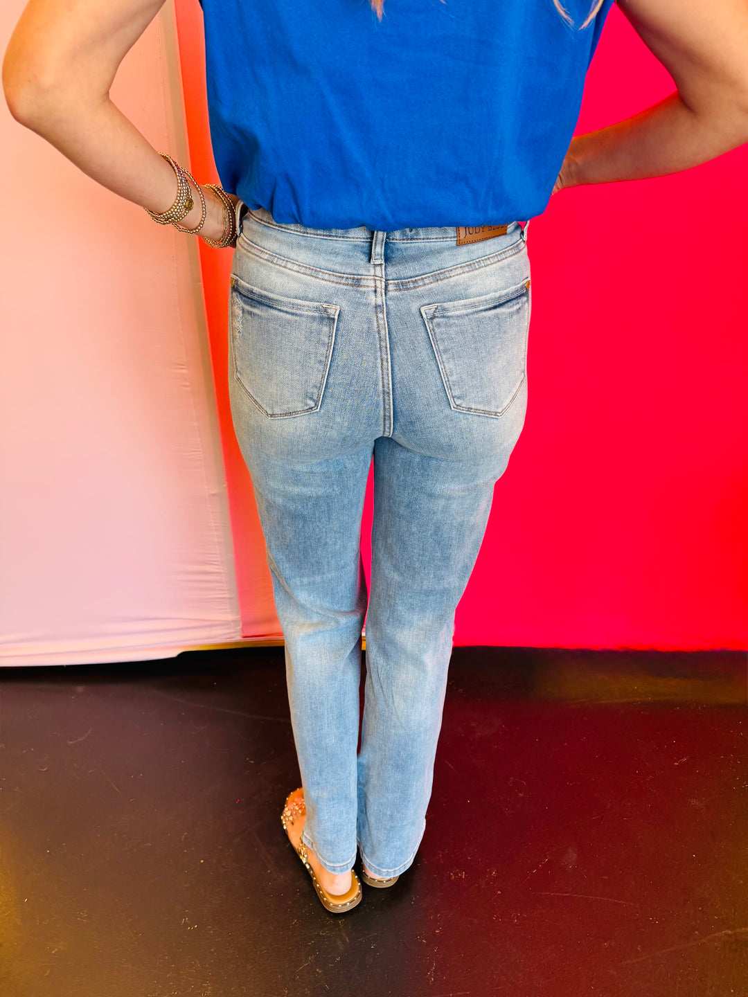 Back view of Judy Blue Contrast Wash Straight Jeans showing pocket placement and full-length straight leg cut designed to enhance and flatter the figure.