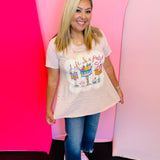 Graphic tee with pastel cake design, rhinestones, and distressed vintage style