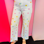 White cropped wide-leg jeans with pastel polka dots and high-rise fit.