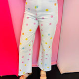 White cropped wide-leg jeans with pastel polka dots and high-rise fit.