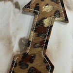 Arrow-shaped leather and hair-on-hide reusable car freshener charm designed for re-scenting with oils.