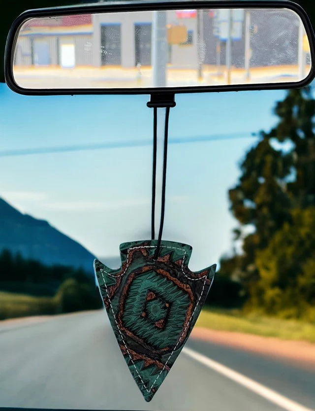 Arrowhead leather and hair-on-hide reusable car freshener charm designed for re-scenting with fragrance oils.