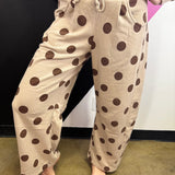 Ash mocha barrel-leg pants with bold brown polka dots and elastic waistband.