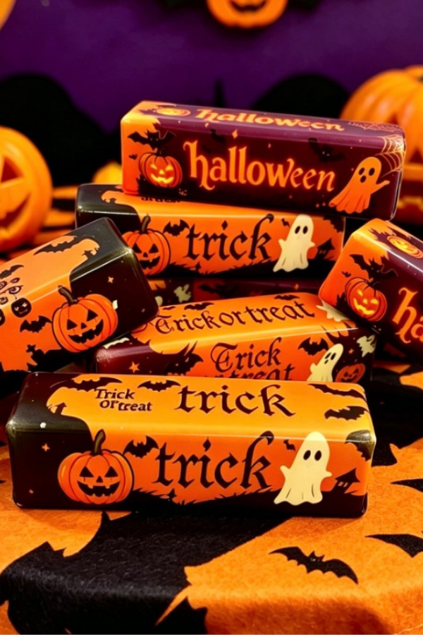Halloween butter stick squishy toys with pumpkins, ghosts, bats, and trick-or-treat designs.