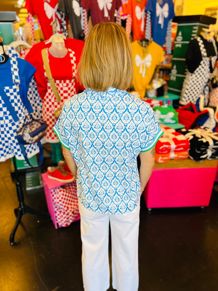 back view of blue and white geometric floral half zip top