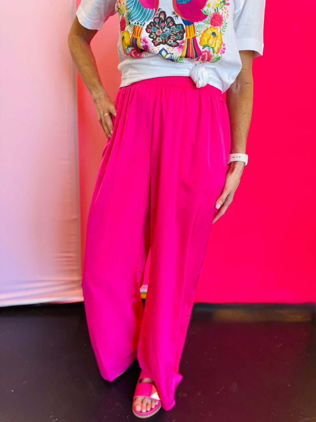 Close-up of the Hot Pink Straight Leg Pants showcasing the vibrant satin fabric, subtle shine, and elastic waistband detail.