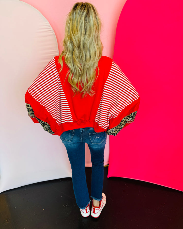Back side of Red, stripe, and leopard oversized Dolman style long sleeve sweatshirt.