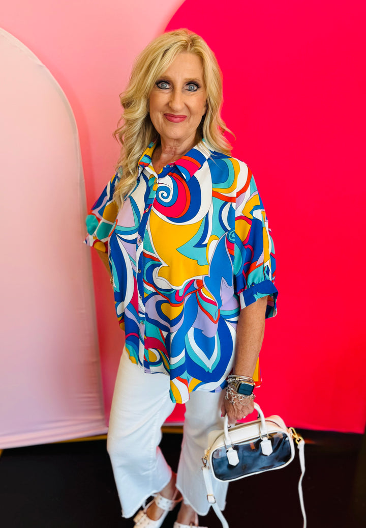 Full-body view of the Blue Printed Blouse styled with white pants and a white handbag, highlighting the blouse’s loose fit and everyday elegance.