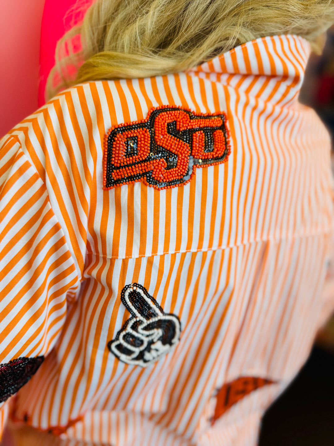 Close up of Queen Of Sparkles orange and white striped icon Oklahoma State University game day blouse.