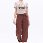 High-rise espresso brown barrel jeans with rolled cuffs and subtle side seams in a cropped fit.