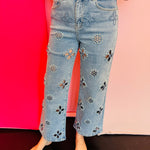Light wash high rise jeans with floral cutout embroidery and pearl embellishments