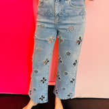 Light wash high rise jeans with floral cutout embroidery and pearl embellishments