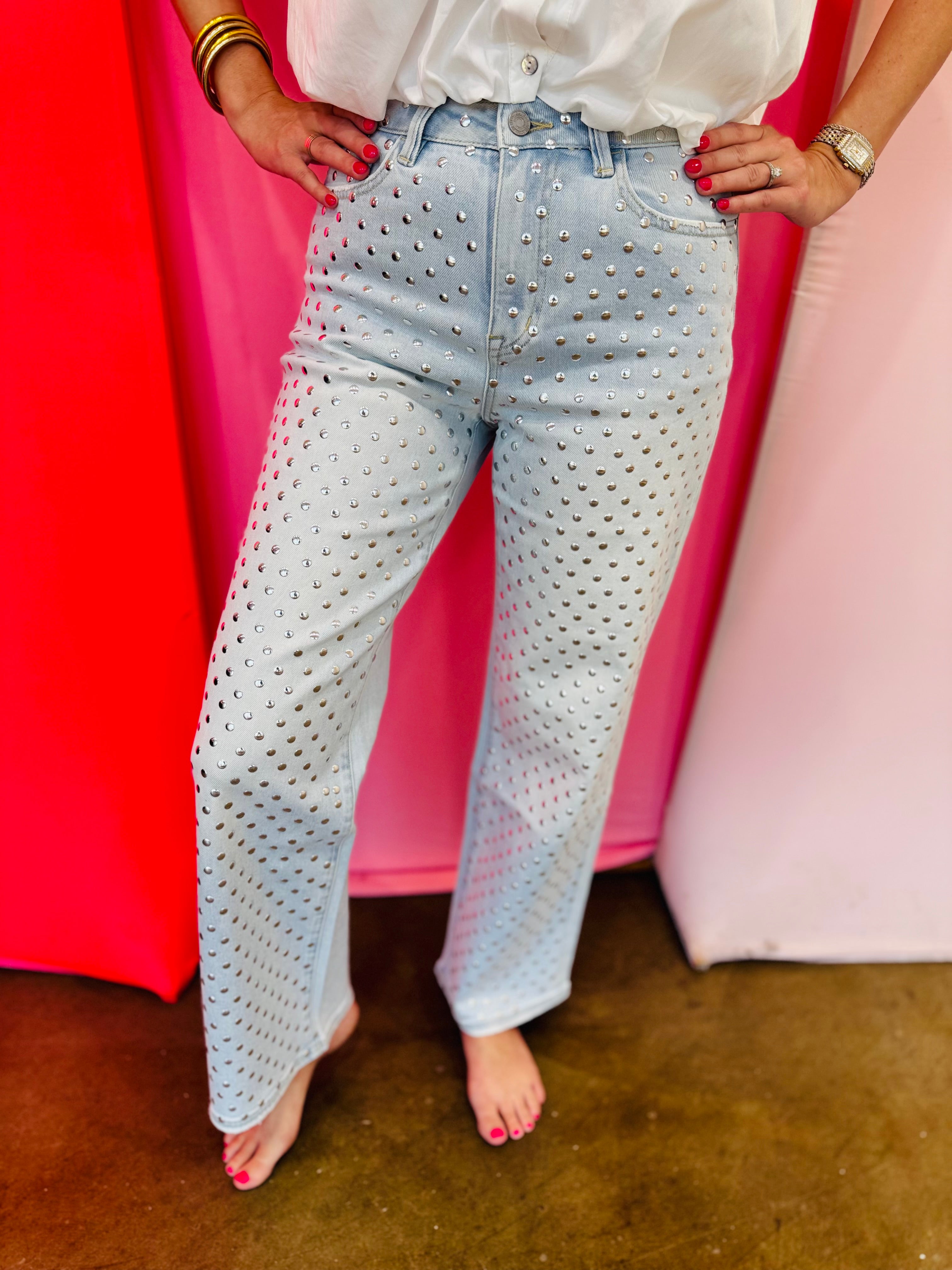 Light wash straight leg jeans with allover rhinestone embellishments and high-rise waist.
