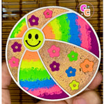 Beach ball freshie with smiley face, flowers, and glitter accents.