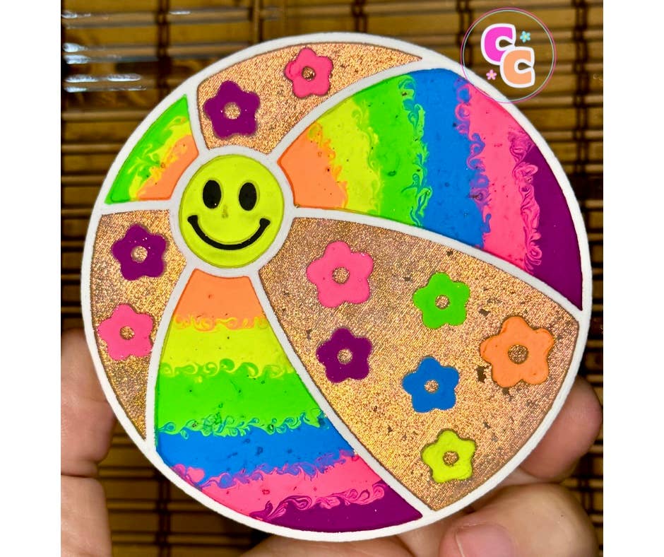 Beach ball freshie with smiley face, flowers, and glitter accents.