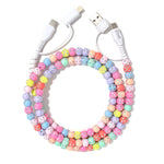 A vibrant, multi-colored beaded phone charger cable with pastel hues and rhinestones. 
