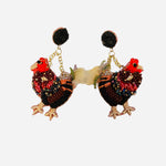 Beaded hen earrings in earthy tones with black stud and gold chain detail.