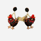 Beaded hen earrings in earthy tones with black stud and gold chain detail.