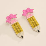 Handmade beaded pencil earrings with pink bow accent, perfect teacher back-to-school jewelry.