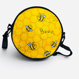 Yellow bee crossbody purse with honeycomb print and zip closure.