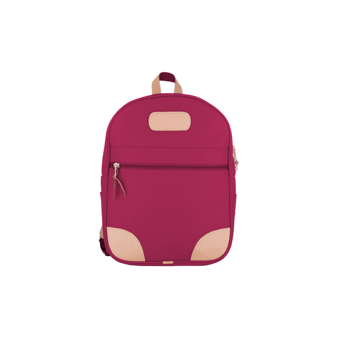 Jon Hart berry coated canvas backpack with Natural Leather trim, front zip pocket, two side pockets, and adjustable leather-detailed straps.