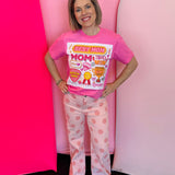 Pink graphic tee with Best Mom collage design, bright stickers, phrases, and bling accents