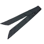 Black and white polka dot twilly scarf styled on neck and purse
