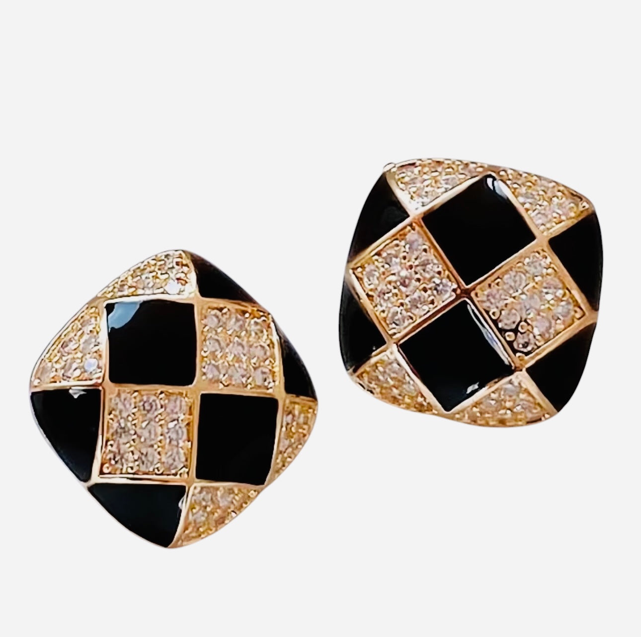 Black and white checkered enamel stud earrings with rhinestone accents.